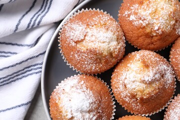 Delicious sweet muffins on grey table, top view