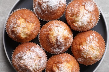 Delicious sweet muffins on light grey table, top view
