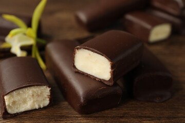Glazed curd cheese bars on wooden table, closeup
