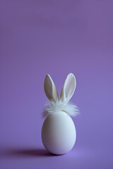 
white egg with fluffy bunny ears isolated on lilac background