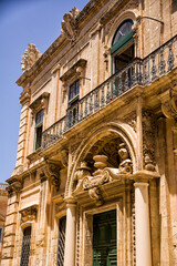 Facade of a building, door and balconies with worked structure in the center of Mdina (Malta) - 739219735