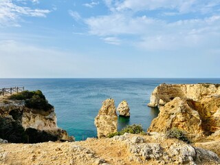 Rocky ocean coast, cliff, azure ocean surface, formation