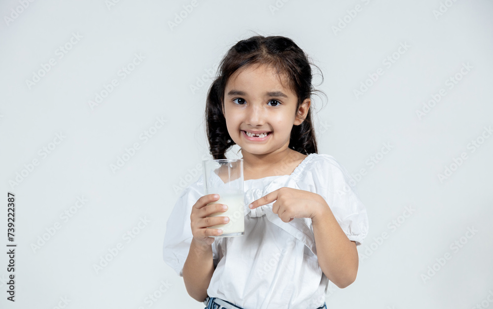 Wall mural portrait of indian kid with glass of milk in hand on isolated background