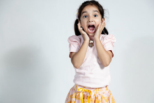 Indian child surprised expression with hand on face on isolated background