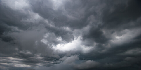 Obraz premium Bad or moody weather sky and environment. climate change. carbon dioxide emissions, greenhouse effect, global warming.The dark sky with heavy clouds converging and a violent storm before the rain.