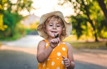 A child catches a butterfly in nature. selective focus.