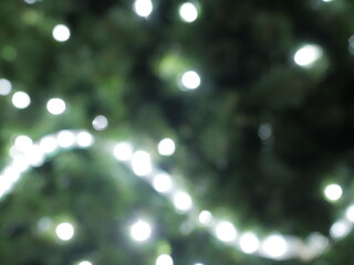 Abstract christmas background in bokeh. Green lights of blinking garland in blur