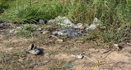 Garbage on the ground, old shoes, environmental protection waste disposal, waste separation, photography Garbage scrap, dirty sand, Background environment