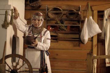 portrait of a woman in national Chuvash clothes in the interior of a Chuvash dwelling in the national Museum