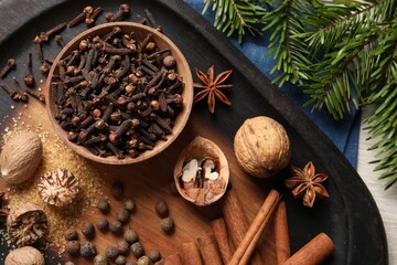 Different spices and fir branches on table, flat lay