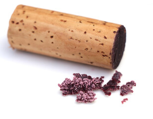 red wine cork and dry crystallized wine sediment on a white background 