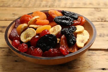 Mix of delicious dried fruits on wooden table, closeup