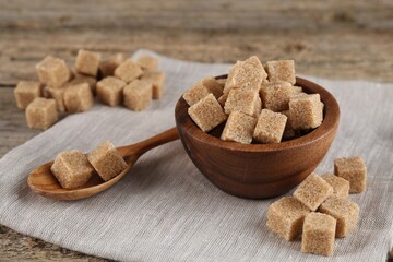 Many brown sugar cubes on table, closeup