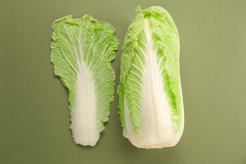Fresh ripe Chinese cabbage and leaf on olive background, top view