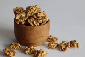 Pristine pile of premium dry walnuts in a wooden bowl, ideal for culinary creations and healthy snacks.