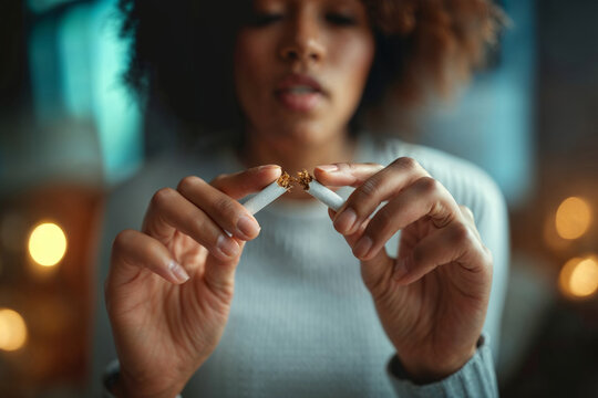 Quit Smoking Concept: Woman Breaking Cigarette in Half