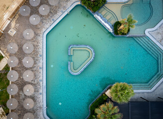 Drone aerial of empty abandoned deserted swimming pool. Dirty water abandoned place.