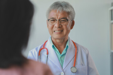 male medical practitioner reassuring a patient, Doctor and patient in conversation, Asian male...