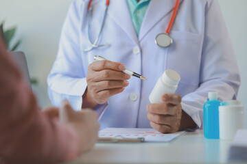 The doctor is explaining the details of the medicine that the patient must take, A patient comes to see the doctor about the problem of side effects from taking medicine.