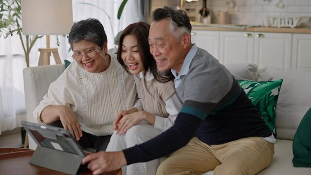 Happy asian senior elderly and daughter have fun with smartphone to talk to online wave hand to webcam glad to say hello.Smiling mature male calling,app for video conversations,enjoy family retirement
