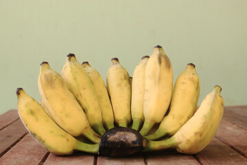 Banana fruit with wooden on blurred background