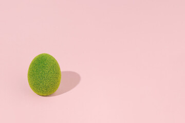 Egg-shaped topiary, minimalistic Easter holiday greeting layout, pastel pink copy space.
