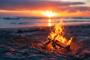 Fotobehang bonfire on the sandy beach during sunset. camping outdoors lifestyle with beautiful scenery landscape © Rangga Bimantara