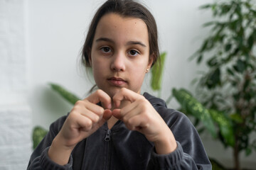 Fototapeta na wymiar Beautiful smiling deaf girl using sign language.