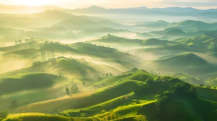 Schilderijen op glas Beautiful aerial View of hilly landscape in morning mist with sun rays, banner format  © Ziyan