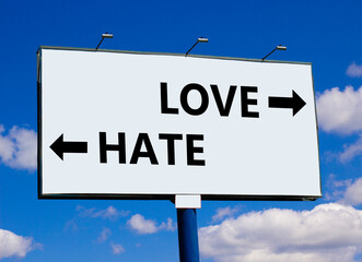 Love or hate symbol. Concept word Love or Hate on beautiful billboard with two arrows. Beautiful blue sky with clouds background. Business and love or hate concept. Copy space.