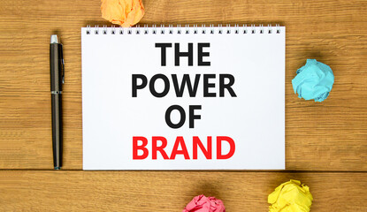 The power of brand symbol. Concept words The power of brand on beautiful white note. Beautiful wooden table background. Colored paper. Black pen. Business the power of brand concept. Copy space.