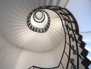 Spiral staircase still life with black ornament railing top view