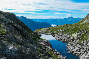 Small high altitude alpine lake surrounded by rocks in High Tauern National Park, Carinthia,...