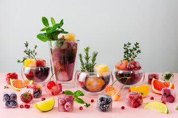 Cool refreshing drinks with ice cubes with berries and fruits and mint, summer cold drink