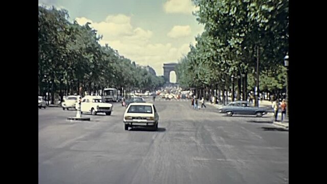 PARIS, FRANCE - CIRCA 1976: Avenue de la Grande Armee to Arch of Triumph. Arc de Triomphe street with car traffic. Historic restored footage on 1970s.