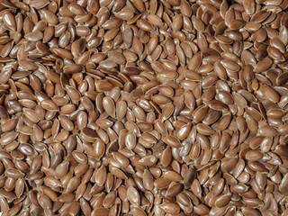 Pattern of flax seeds as background. Healthy food. Proper nutrition. Fibers. Close-up, macro photography.