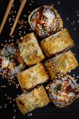 fried tempura Hokkaido rolls on a black stone