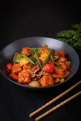 Korean food, Tofu with vegetables and meat in sauce on a black background