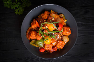 Korean food, Tofu with vegetables and meat in sauce on a black background