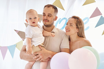 Happy toddler's first birthday party with family's loving presence.