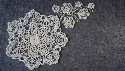 Beautiful white crochet openworks on dark marble table.  Lace Vintage background Copy space. - obrazy, fototapety, plakaty