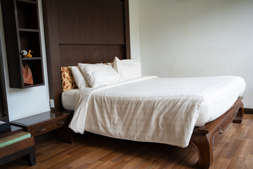 Fototapeta na wymiar Cozy clean bedroom in tropical resort villa luxury hotel