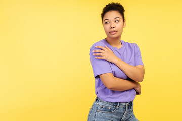 Enchanting photo of young woman, safeguarding herself with her hands and averting her gaze