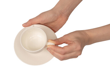 Female hand holding coffee cup and saucer isolated on white background.