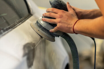 Bulgarian mechanic working in auto shop.