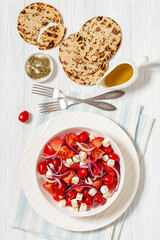 tomato salad with red onion and white cheese