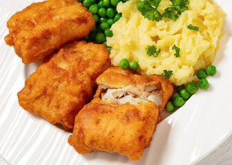 fried fish with mashed potatoes and green peas