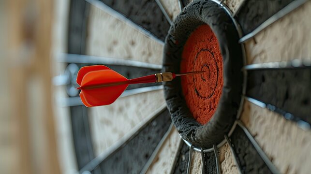 Bullseye target or dart board has red dart arrow throw hitting the center  for business targeting and winning goals