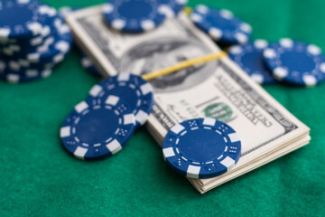 Poker chips, dollars and a pair of aces