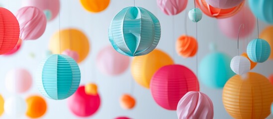 Vibrant array of colorful paper lanterns hanging elegantly from a delicate string - Powered by Adobe